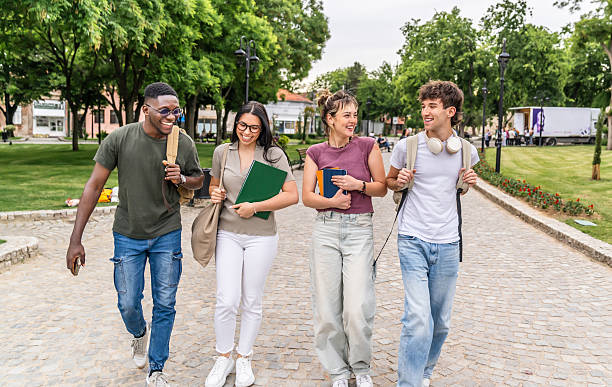 istock Cheerful university students walking and talking outdoors 2225123080