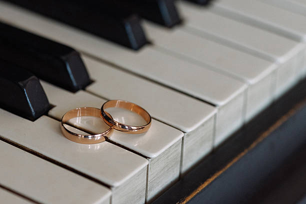 istock Two wedding rings on piano keys. 2225124509