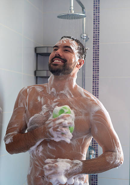 istock Young happy man showering in the morning 2225126978