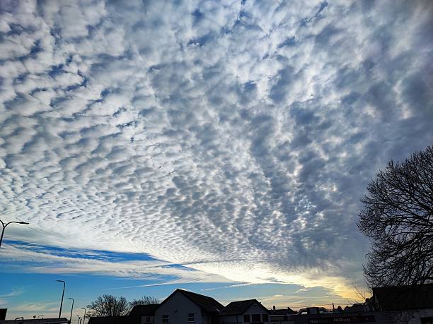 Dramatic clouds in the sky, South Wales UK. Dramatic dark grey, medium grey, light grey, white clouds, with a hint of blue sky.