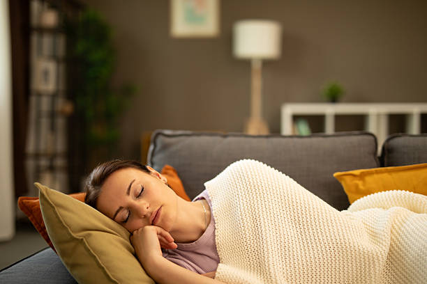 istock Serene woman sleeping peacefully on comfortable sofa at home. Stock image 2225127287