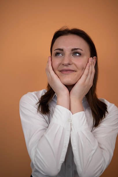 istock Young businesswoman dreaming with hands on cheeks. Stock image 2225127983