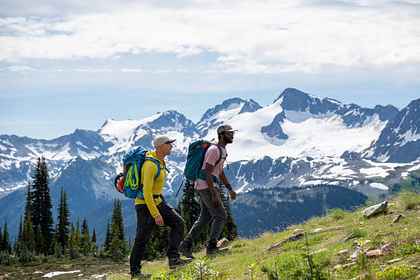 istock Climbing guide leads guest up mountain 2225128276