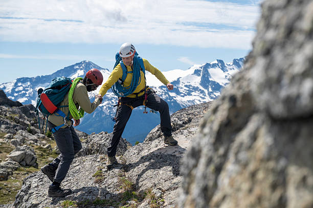 istock Climbing guide leads guest on mountain ridge 2225129167