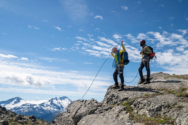 istock Climbing guide leads guest on mountain ridge 2225129627
