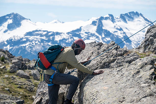 Climbing guide leads guest on mountain ridge