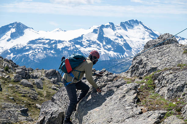 istock Climbing guide leads guest on mountain ridge 2225129867