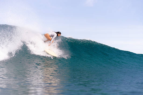 istock Lady surfer taking off on a big wave - Indonesia 2225130197