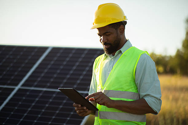 istock Engineer using digital tablet while inspecting solar panels in solar power station. Stock image 2225130833