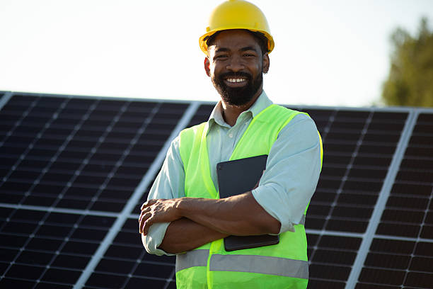 istock Smiling engineer inspecting solar panels at power plant. Stock image 2225130851