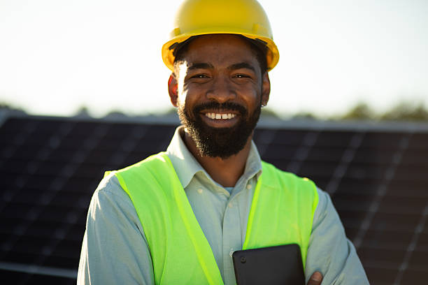 istock Smiling engineer holding tablet and inspecting solar panels installation. Stock image 2225130861