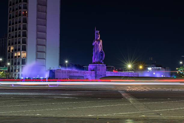Guadalajara, Mexico - March 1 2025: La Minerva statue in Guadalajara at night captured with light trails from passing traffic