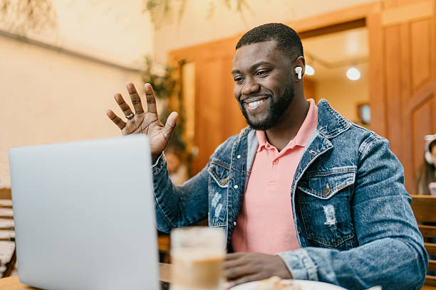 istock Freelancer waving during video call at cafe 2225132072