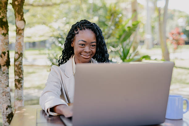 istock Businesswoman using laptop outdoors in garden setting 2225132122