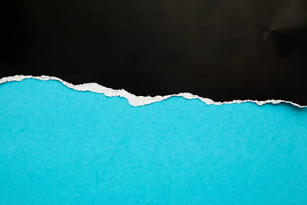 istock Black ripped paper torn edges strips isolated on blue background 2225133188