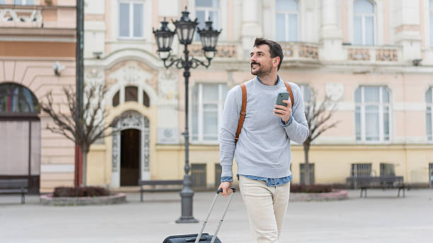 istock Man strolling with suitcase in beautiful urban surroundings 2225133253