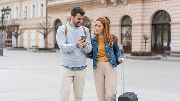istock Amused Couple Observing Their Smartphone Together 2225133255