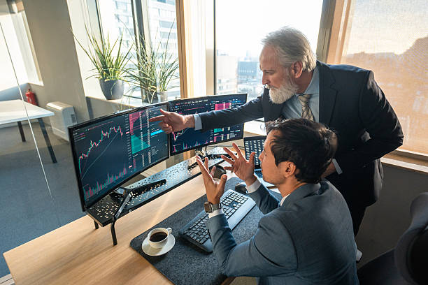 istock Mature Stock Brokers Analyzing Financial Data in Modern Office 2225134540