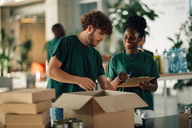 istock Volunteers preparing donation packages in community center 2225137538