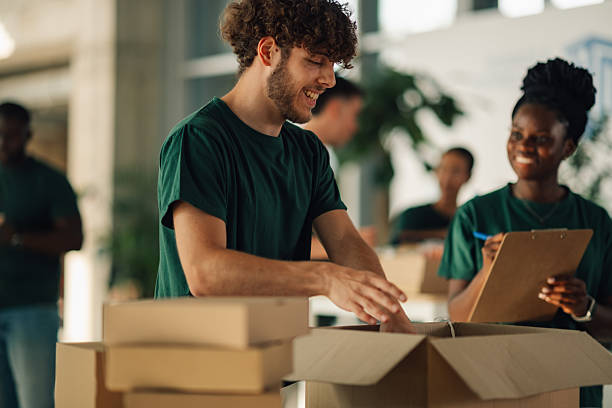 istock Volunteers preparing donation packages in community center 2225137548