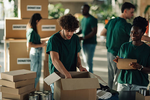 istock Volunteers preparing donation boxes at charity organization 2225137549