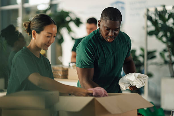 istock Volunteers preparing clothes donations in cardboard boxes 2225137560