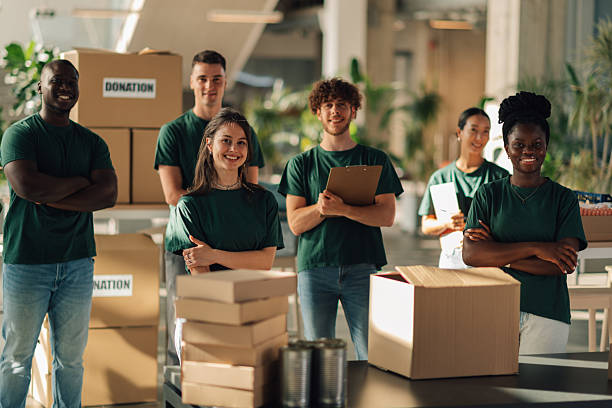 istock Volunteers smiling at camera in donation center warehouse 2225137569