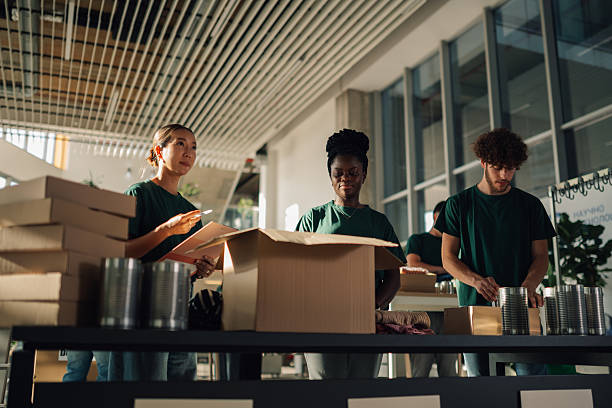 istock Volunteers preparing donation boxes with food and clothes 2225137571