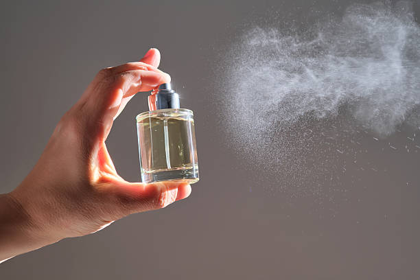 istock The hand sprays perfume from a transparent rounded bottle. 2225137621