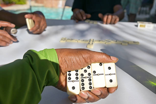 Men at the park playing a game of dominoes