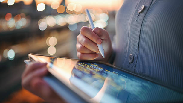 istock Gen Z asian woman combines a smartphone and stylus for efficient note-taking  multitasking and digital productivity  multitasking and digital productivity. Perfect for visual content around mobile office tools, tech-integrated workflows, and business-foc 2225138163