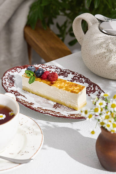 istock Cheesecake slice with mixed berries, bright natural lighting, overhead composition 2225142764