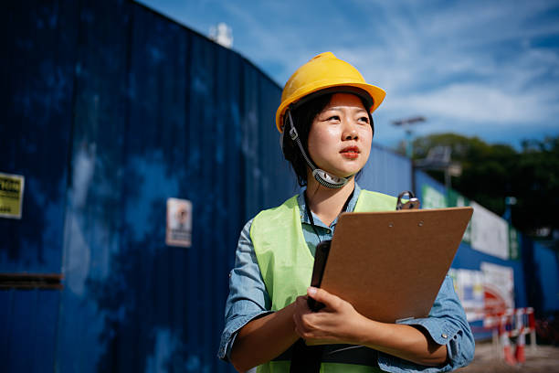 istock Asian Female Construction Engineer Holding Clipboard at Worksite 2225143748