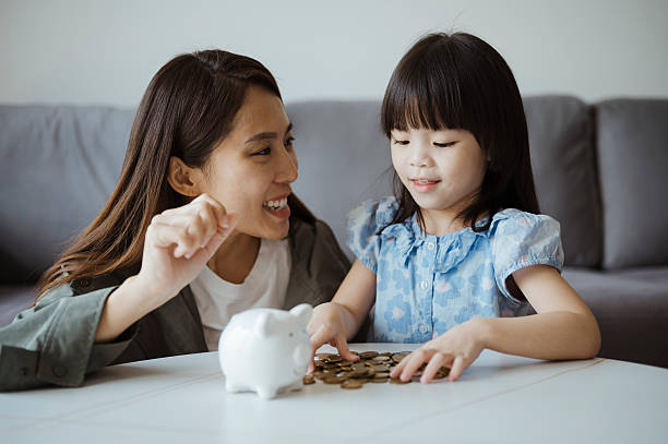 istock Mother Teaching Daughter the Value of Saving 2225145778