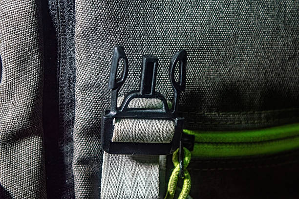 istock Close up of a black backpack buckle and strap on rugged fabric, highlighting durability, grip, and minimalist design. Perfect for outdoor, travel, and adventure lifestyle themes 2225146186