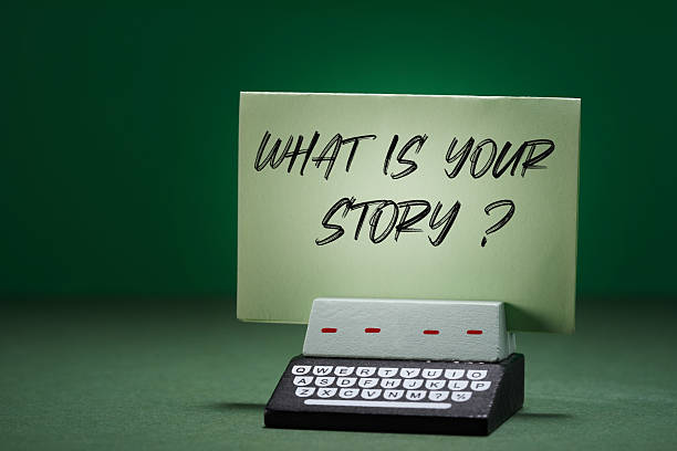 note with text ' what is your story ' on the toy typewriter.