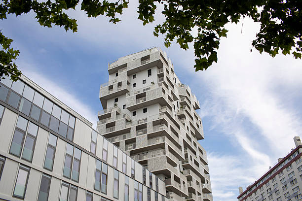 istock Futuristic high-rise apartment buildings viewed through trees 2225148853