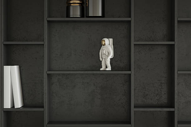istock Space-Themed Decor-Astronaut Figurine on a Dark Modern Bookshelf Display 2225152164