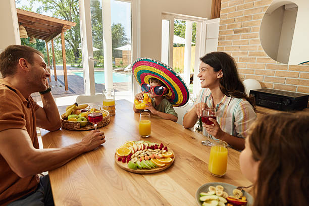 istock Happy family enjoying in conversation during a meal at dining table. 2225152976