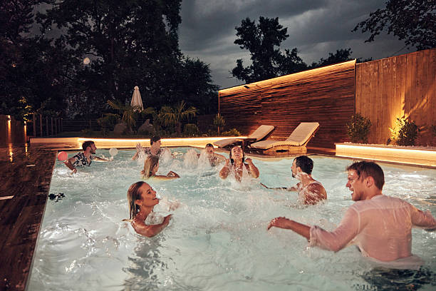 istock Cheerful friends having fun during the pool party at night. 2225153019