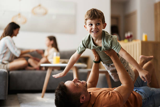 istock Happy boy having fun with his father on carpet at home. 2225153266