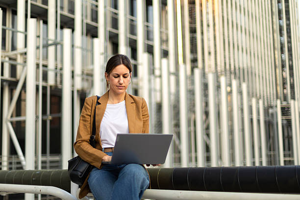 istock Young professional working on laptop outdoors 2225154397