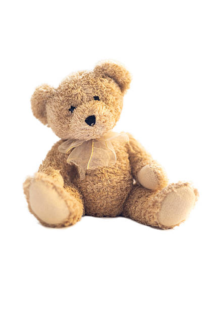 istock Teddy bear with brown bow sitting on white background 2225154455