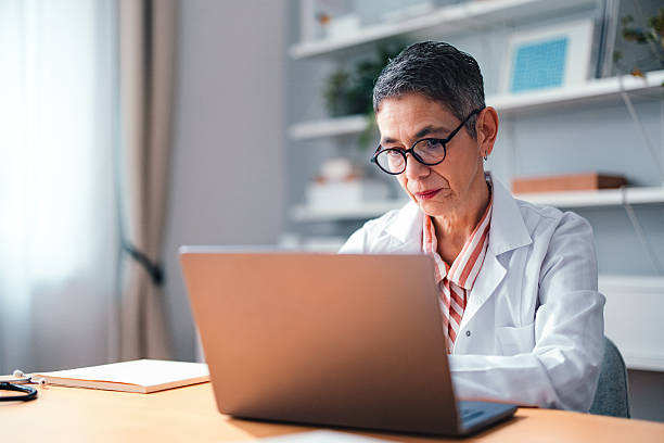 istock Professional Doctor Working on Laptop in a Modern Office Setting 2225157981