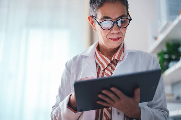 istock Professional Doctor Reviewing Data on a Tablet in a Modern Office 2225158004