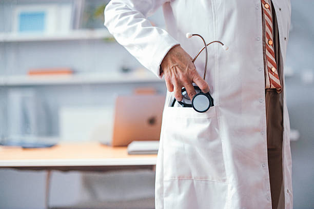 istock Doctor Holding Stethoscope in Office Setting With Modern Background Details 2225158006