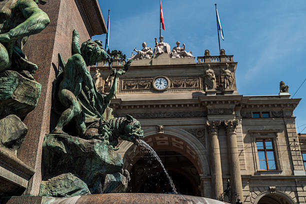 Detailed bronze sculpture from the Alfred Escher Fountain in Zurich, created by Friedrich Schlüth (1844–1919). Featuring a winged dragon and symbolic human figures in daylight.