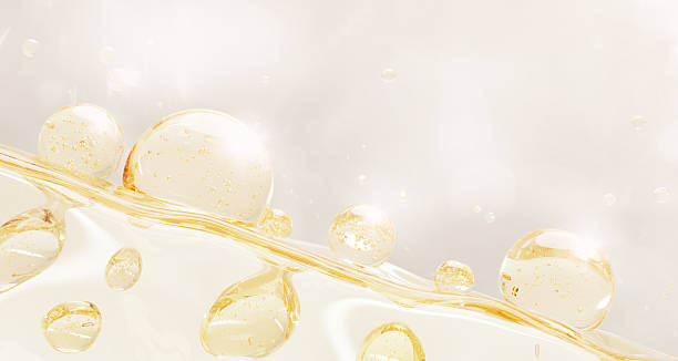 istock 3d gold liquid cosmetic background with wavy surface and oil drops texture. Light yellow clear serum, collagen gel, retinol or biotin vitamin, circle bubbles for skin or hair care 2225163263