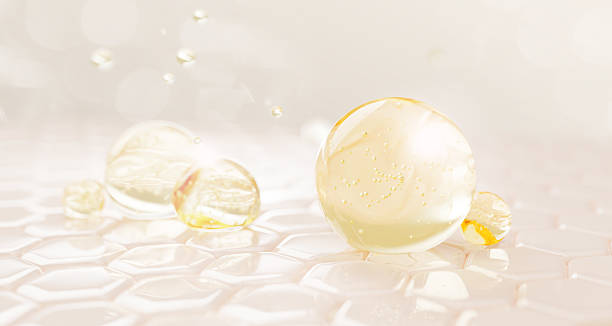 istock 3d epidermis skin layer with hexagon cell pattern and oil drops texture. Light background with gold liquid serum, collagen gel, retinol vitamin bubbles. Cosmetic spheres for skincare 2225163278