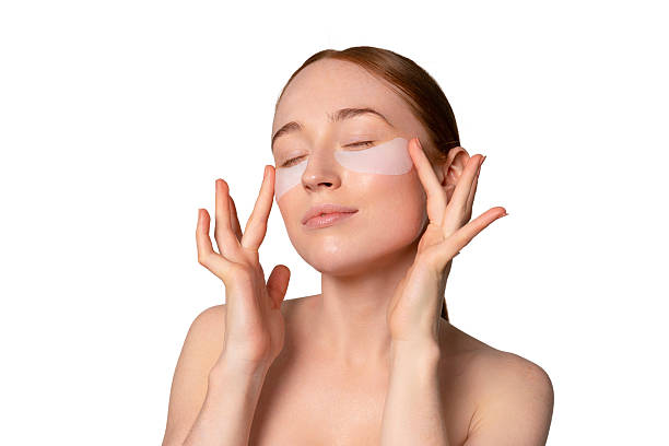 istock Woman applying under-eye patches for skincare routine in bright bathroom setting during morning hours to enhance skin vitality 2225165243